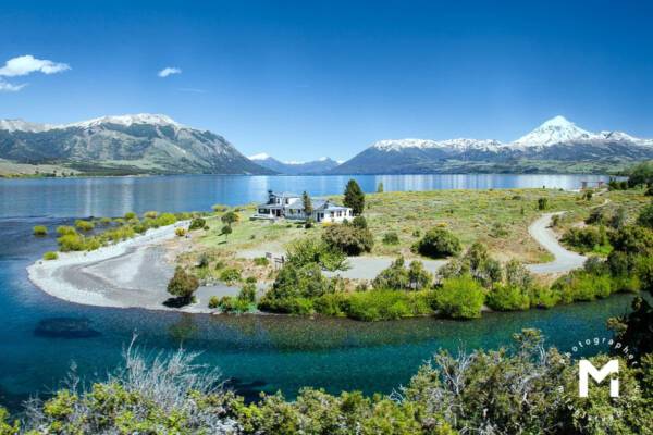 House at the lake in front of mountains