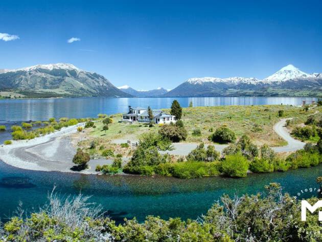 House at the lake in front of mountains
