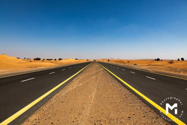 Endless asphalt road in desert