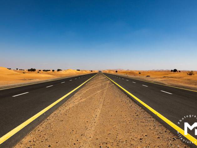 Endless asphalt road in desert