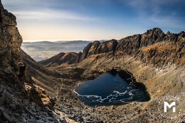 Big mountains valley with the lake