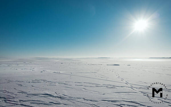 Far view at the frozen snowy lake