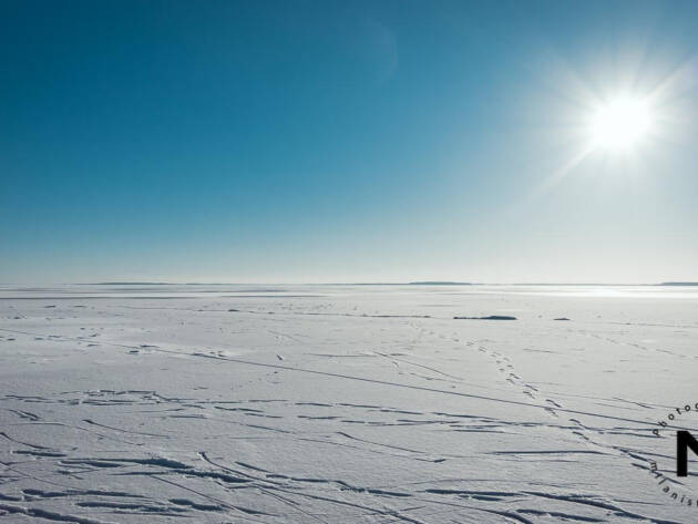 Far view at the frozen snowy lake