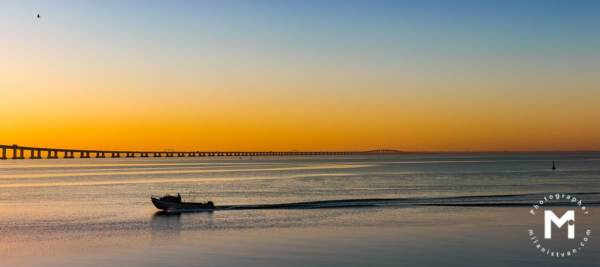 Fisher with the boat at the sunrise