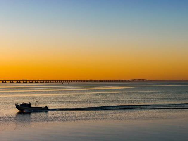 Fisher with the boat at the sunrise