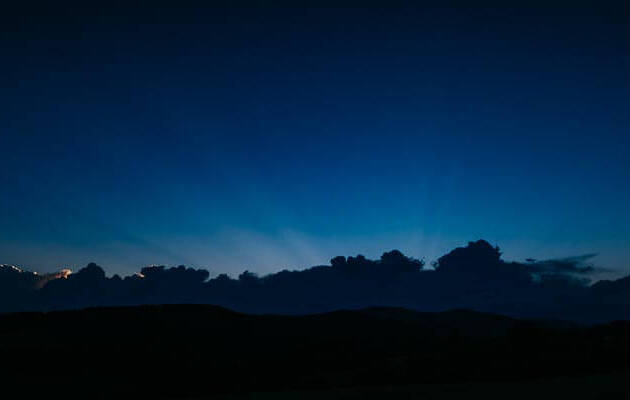 Sunshine behind the clouds and blue sky